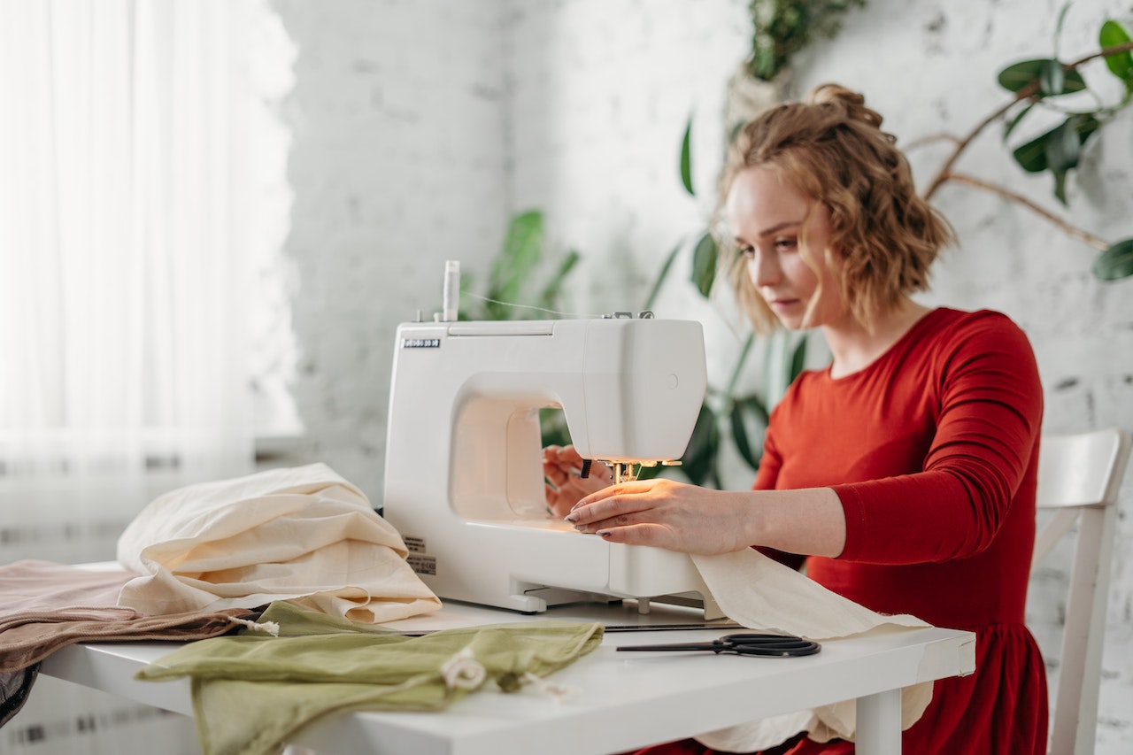Woman using a sewing machine.