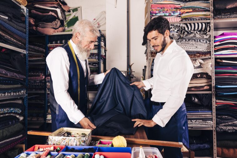 Two tailors working in a textile shop