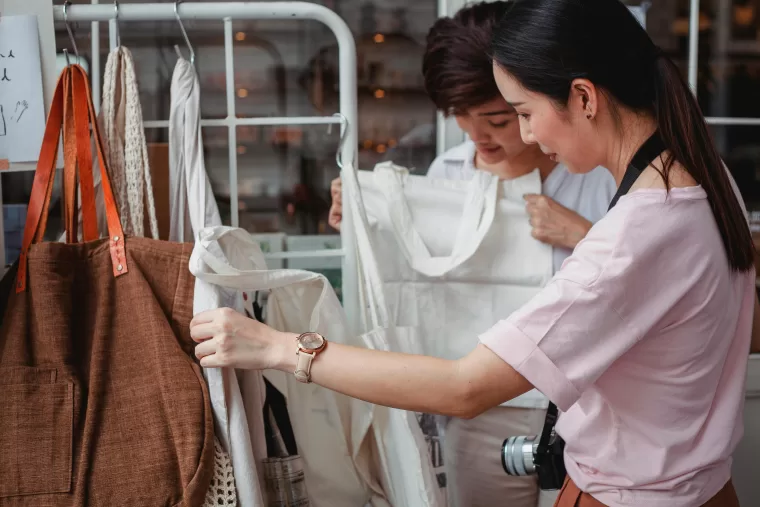 Fashion designers selecting garments made from sustainable materials