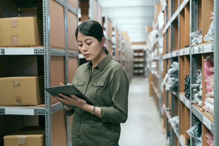 Young woman working on inventory management in a warehouse.