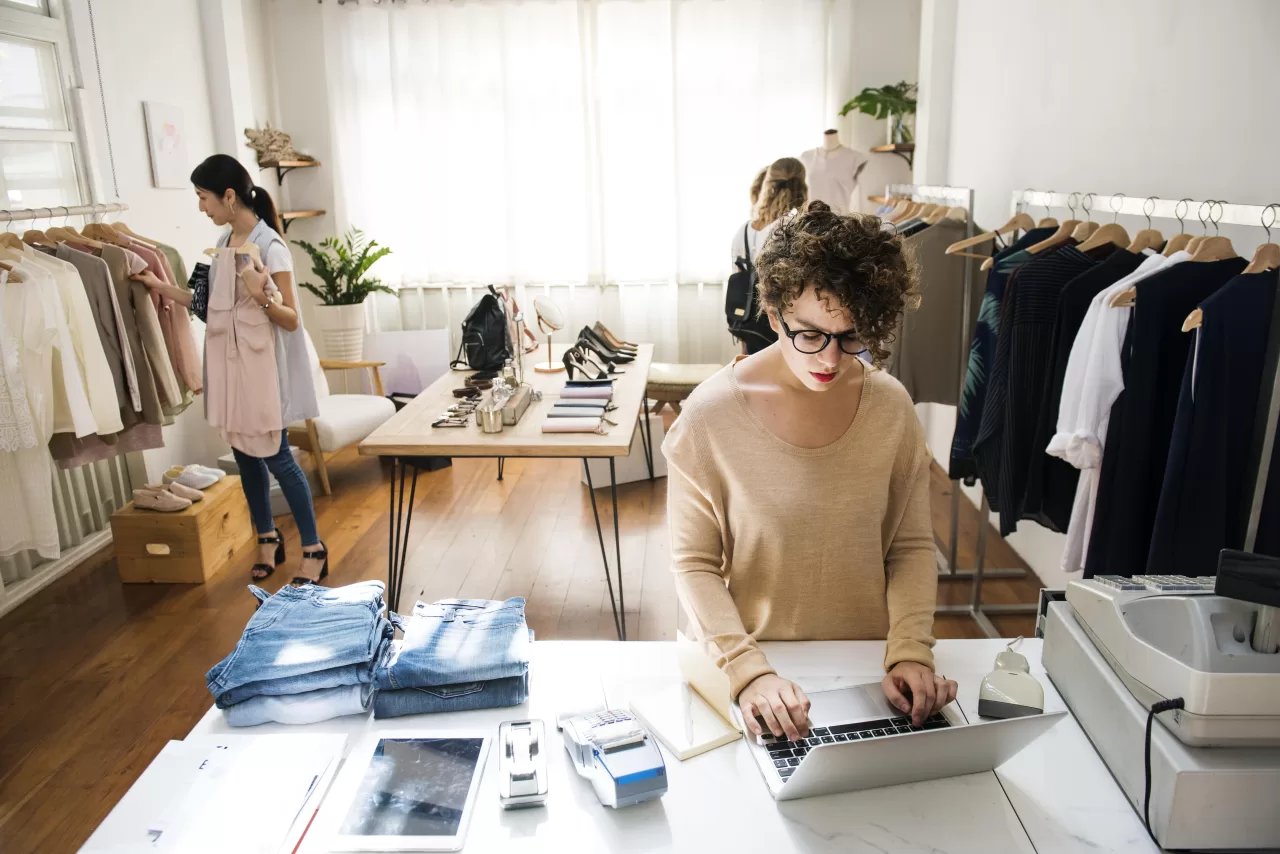 Business owner using ERP software in fashion shop