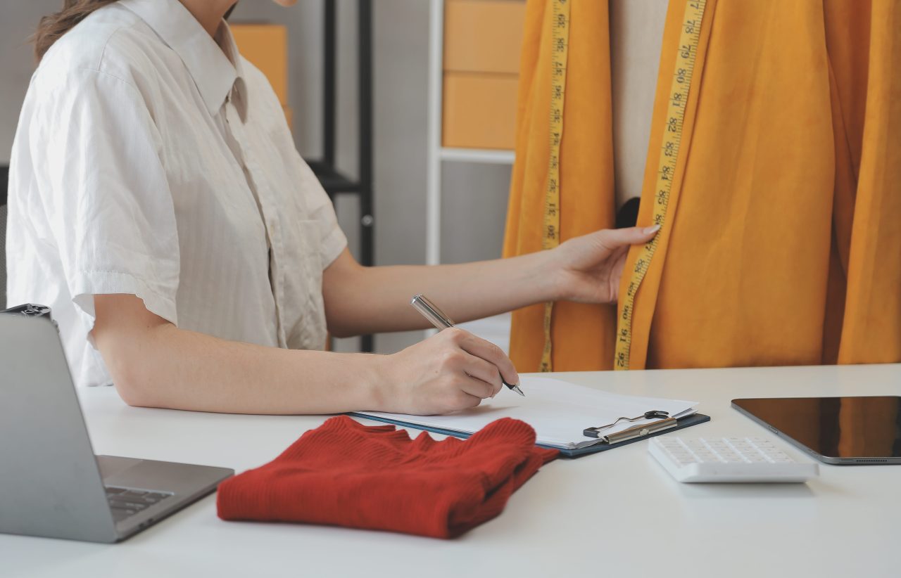Designer measuring jacket in studio