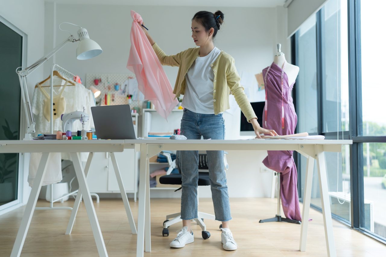 Fashion designer working with materials and computer