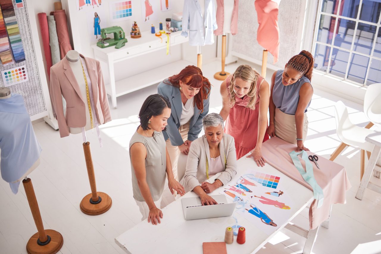 Fashion team huddled around a laptop