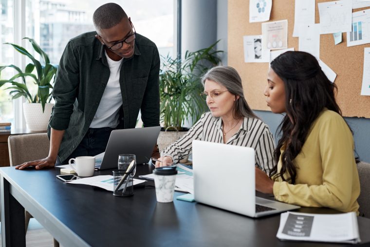 Three colleagues working on ERP implementation