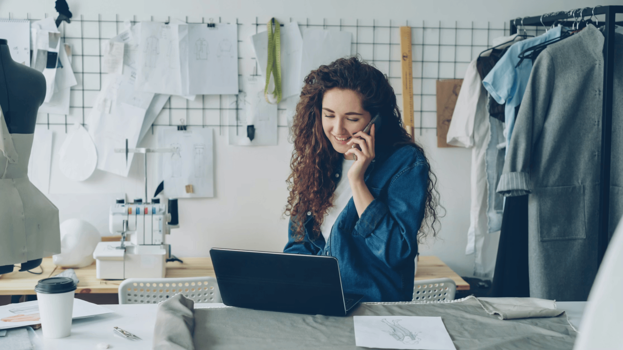 Designer calling from her studio in front of laptop